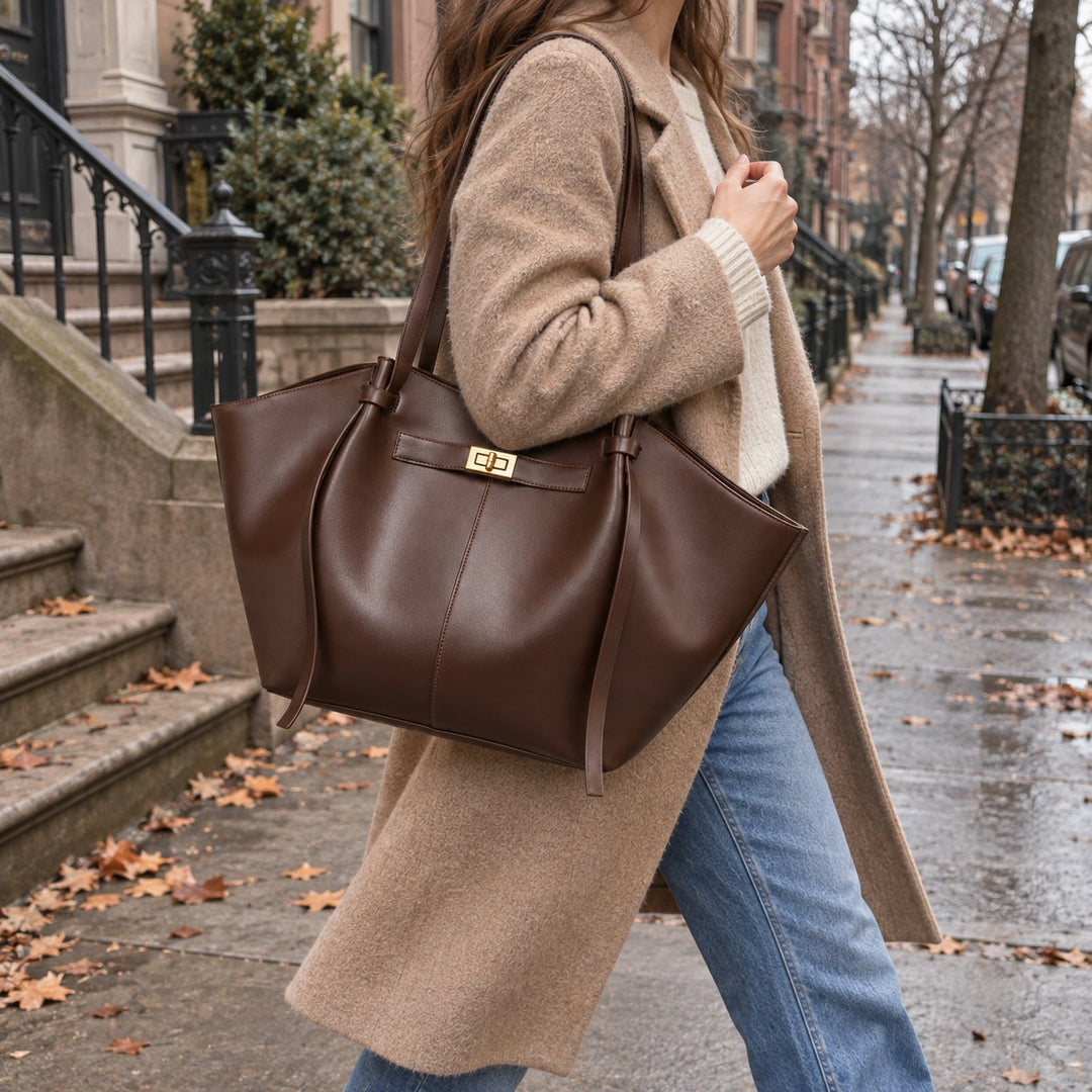 Vela tote in chocolate, carried on the shoulder